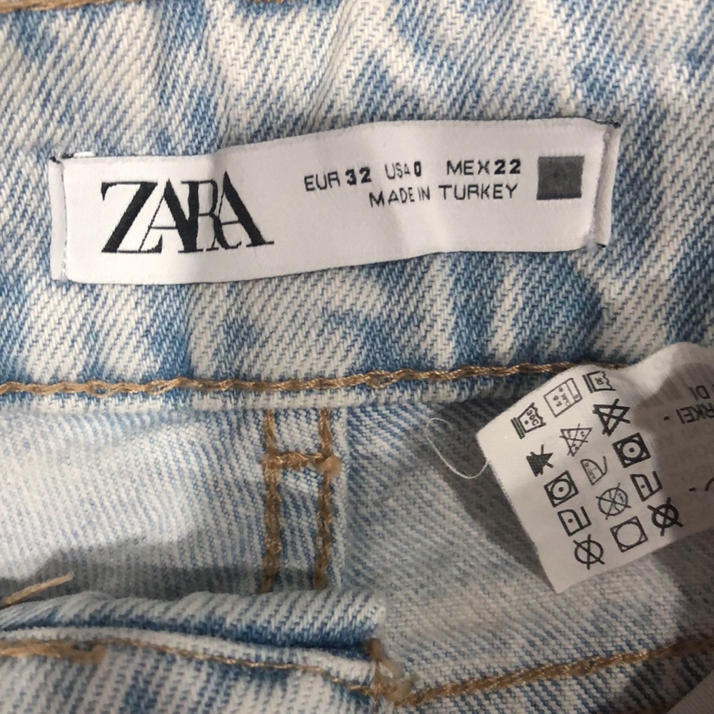 Zara high waisted flare light wash denim jeans.